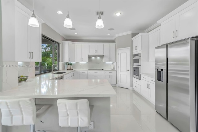 kitchen featuring kitchen peninsula, pendant lighting, stainless steel appliances, and white cabinetry