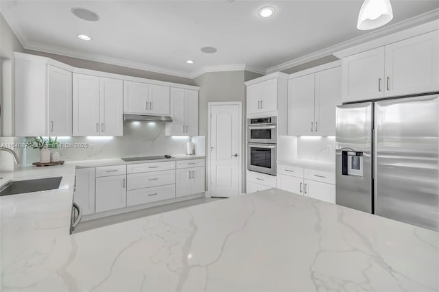 kitchen with light stone countertops, appliances with stainless steel finishes, white cabinets, and sink