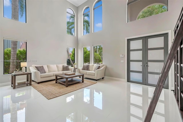 living room featuring french doors and a high ceiling