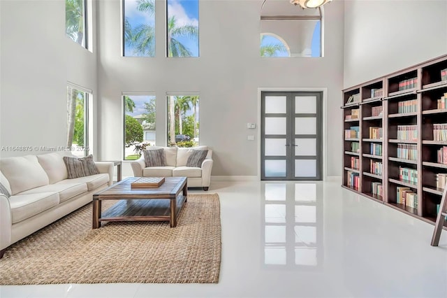 living room with french doors and a towering ceiling