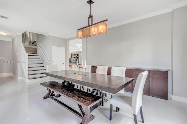 dining space with ornamental molding