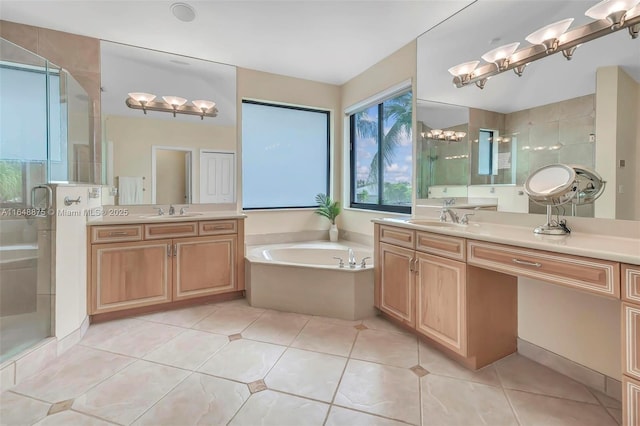 bathroom with tile patterned floors, vanity, and shower with separate bathtub