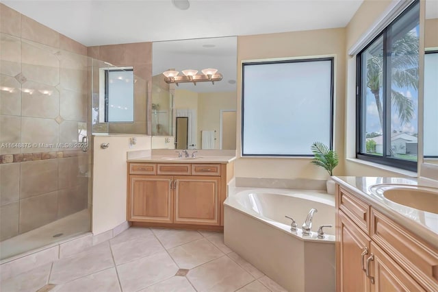 bathroom featuring tile patterned floors, vanity, and separate shower and tub