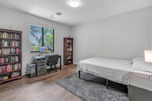 bedroom with hardwood / wood-style floors