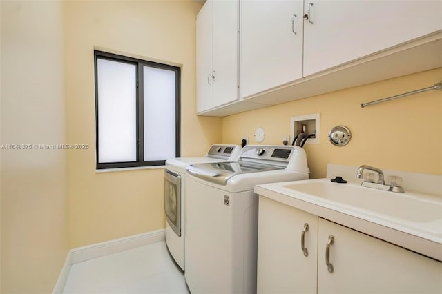 laundry area featuring cabinets, independent washer and dryer, and sink