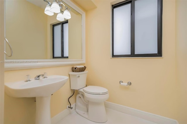 bathroom with tile patterned flooring, toilet, and sink