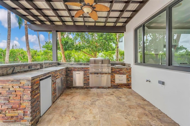 view of patio featuring grilling area, ceiling fan, and an outdoor kitchen