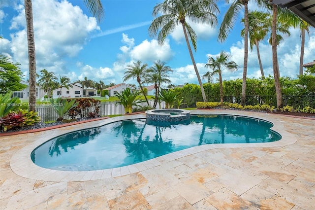 view of swimming pool featuring a patio area and an in ground hot tub