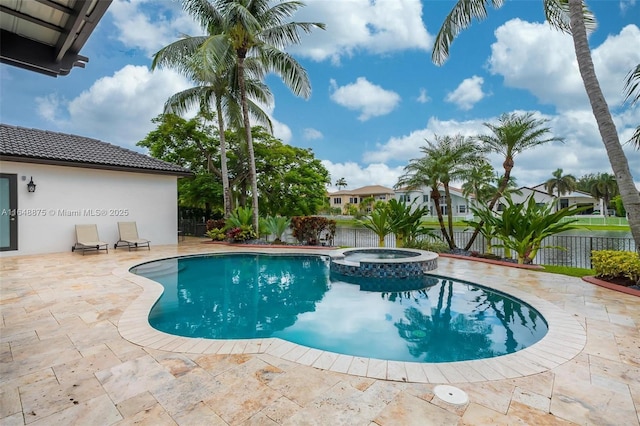 view of swimming pool with an in ground hot tub and a patio