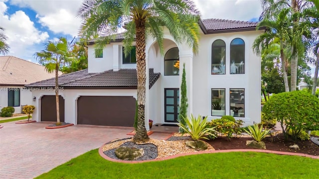 mediterranean / spanish-style house with a garage