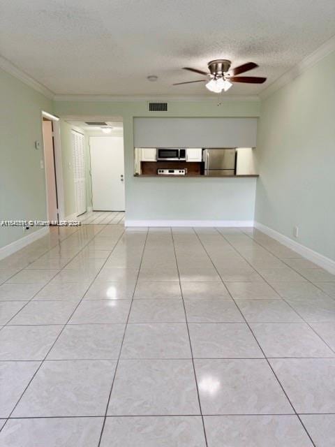 unfurnished room featuring a ceiling fan, a textured ceiling, light tile patterned flooring, and crown molding