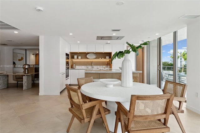 dining area with floor to ceiling windows and sink