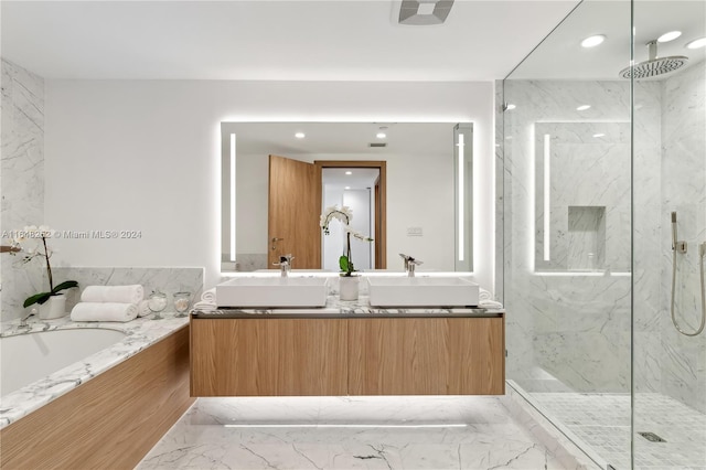 bathroom with vanity and separate shower and tub