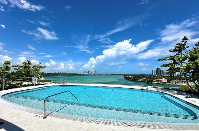 view of swimming pool with a water view