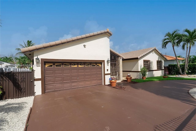 mediterranean / spanish-style house with a garage