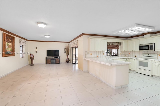 kitchen featuring tile countertops, decorative backsplash, ornamental molding, white electric range oven, and kitchen peninsula