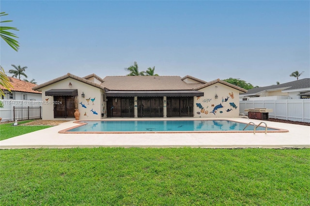 view of swimming pool with a lawn and a patio area