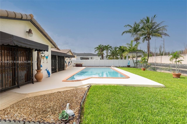 view of swimming pool featuring a patio area and a yard