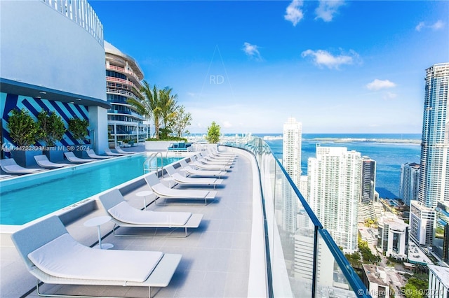 view of swimming pool featuring a water view