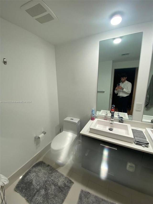 bathroom featuring vanity, toilet, and tile patterned floors