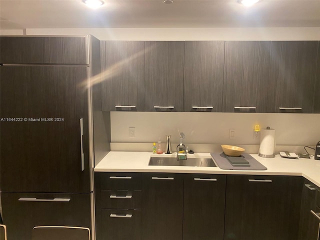 kitchen featuring refrigerator and sink