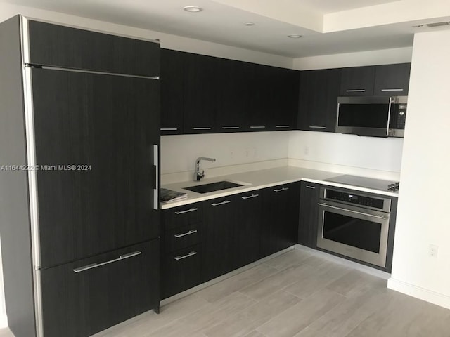 kitchen with light hardwood / wood-style flooring, sink, and appliances with stainless steel finishes