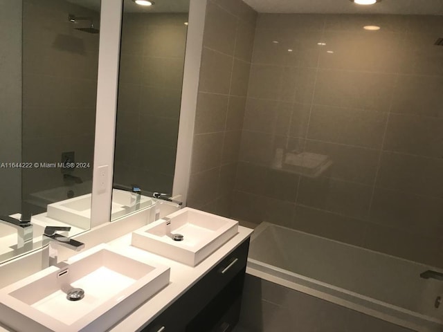 bathroom featuring vanity and tiled shower / bath combo