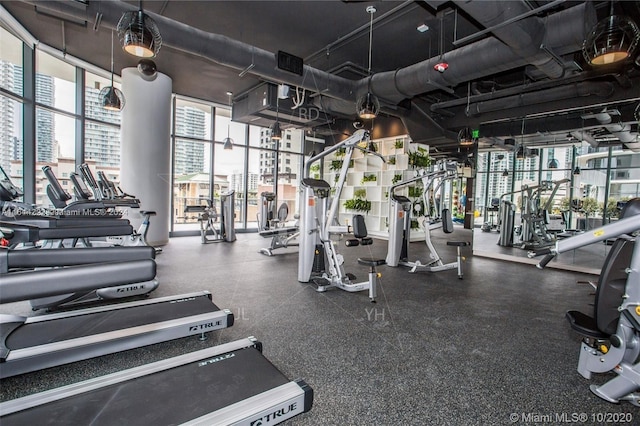 exercise room with floor to ceiling windows