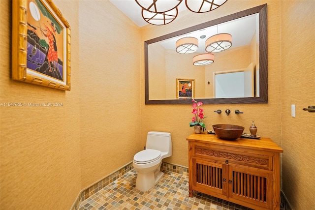 bathroom with vanity, toilet, and tile patterned floors