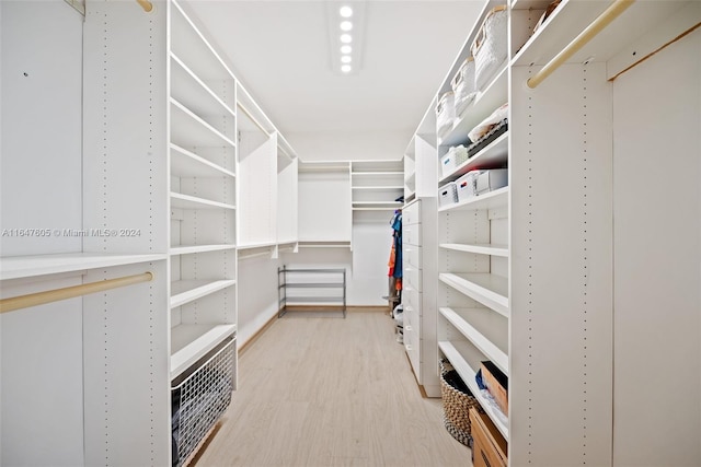 spacious closet with light hardwood / wood-style flooring