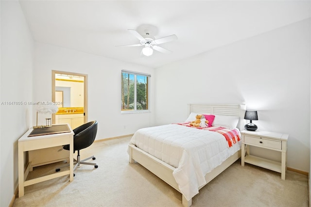 bedroom featuring ceiling fan, light carpet, and ensuite bathroom