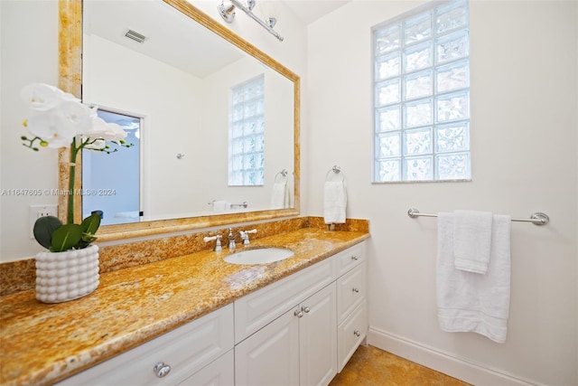 bathroom with tile patterned floors and vanity