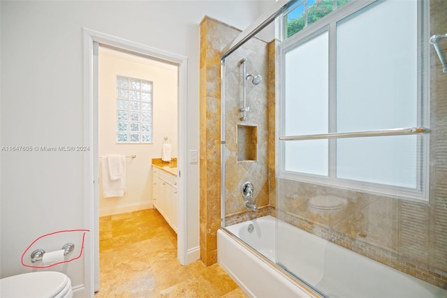 full bathroom featuring tile patterned floors, toilet, bath / shower combo with glass door, and vanity