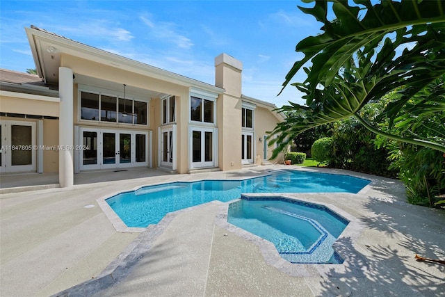 view of pool featuring an in ground hot tub and a patio