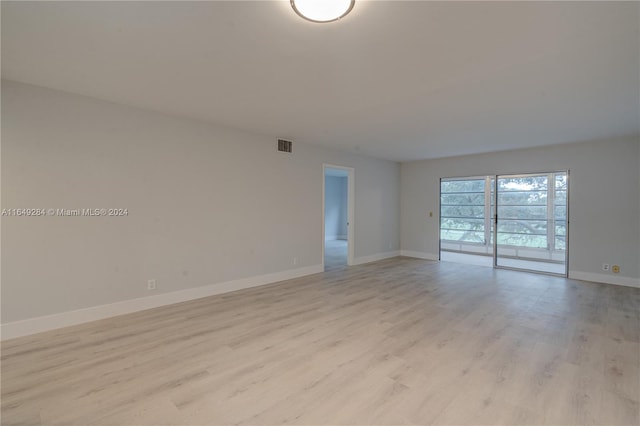 spare room featuring light wood-type flooring