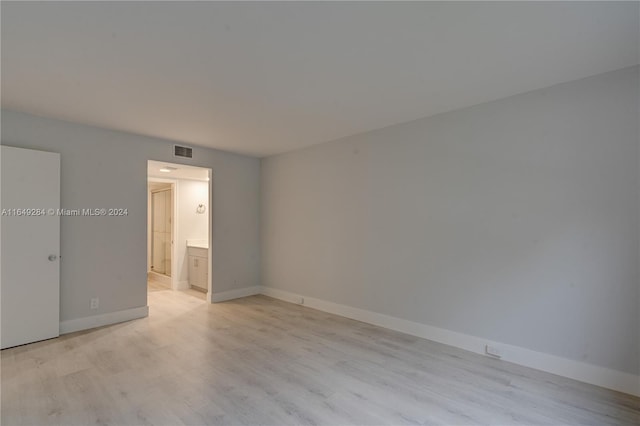 spare room with light hardwood / wood-style flooring