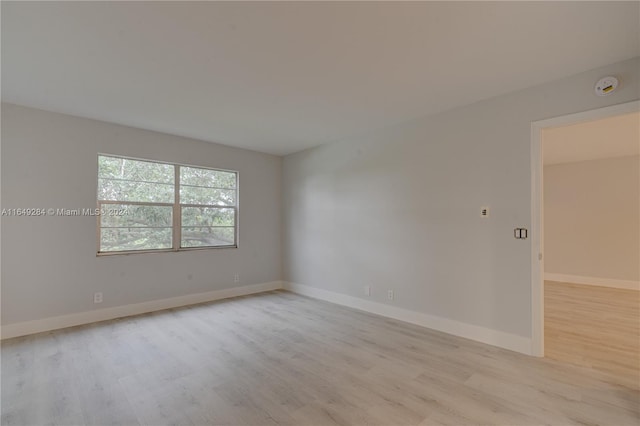 unfurnished room with light hardwood / wood-style floors