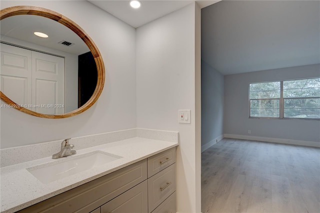 bathroom with vanity and hardwood / wood-style floors