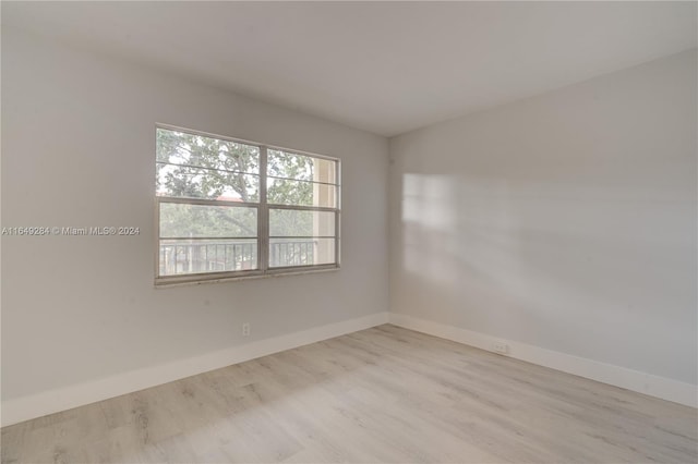 unfurnished room with light hardwood / wood-style floors