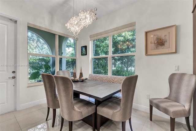 dining room featuring light tile patterned floors and a chandelier