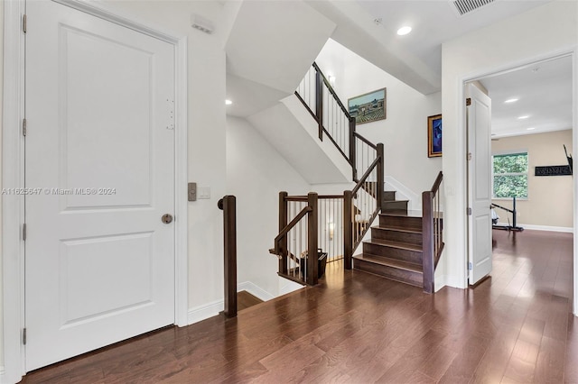 stairway with hardwood / wood-style floors