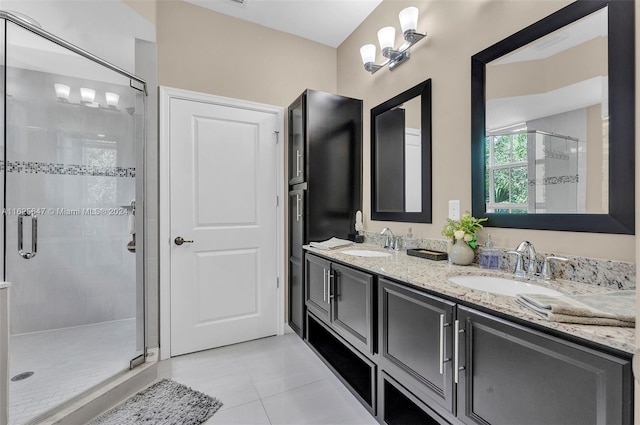 bathroom featuring tile patterned flooring, vanity, and a shower with door