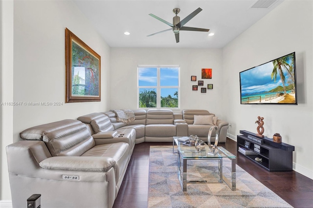 living room featuring dark wood-type flooring and ceiling fan