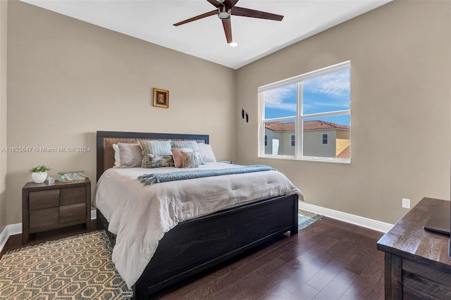 bedroom with ceiling fan and dark hardwood / wood-style floors