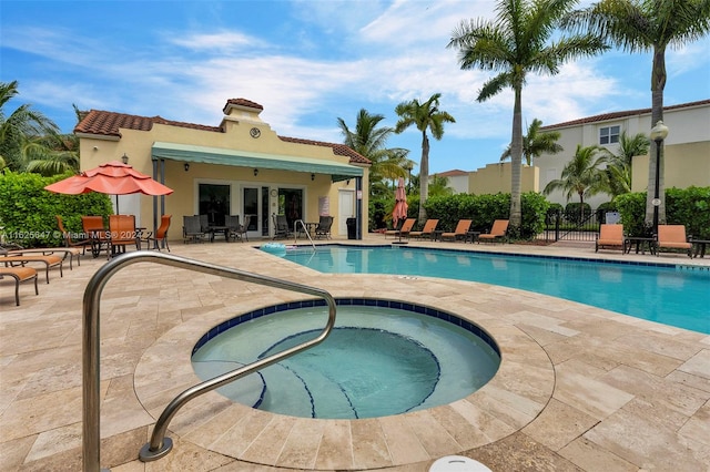 view of pool featuring a community hot tub, french doors, and a patio