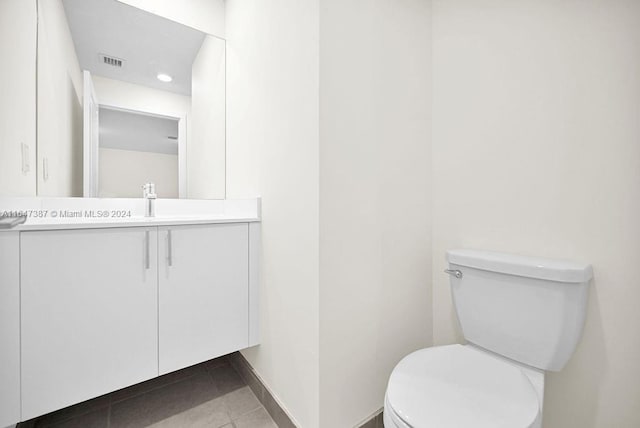 bathroom featuring vanity, toilet, and tile patterned flooring