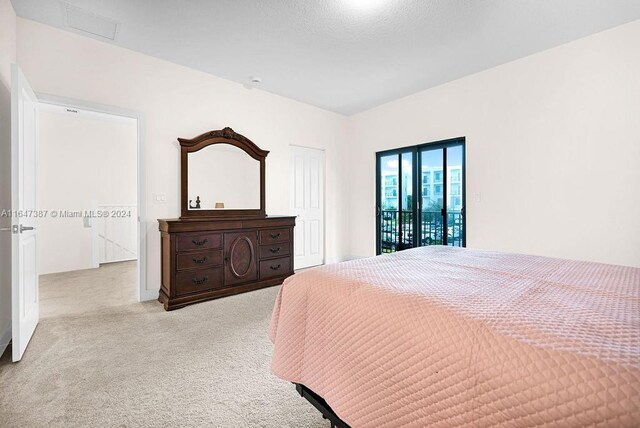 carpeted bedroom featuring access to exterior