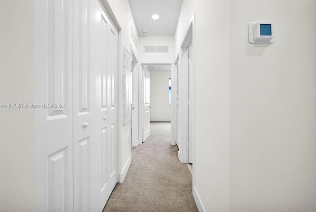 hallway featuring light carpet