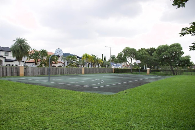 view of sport court with a yard, fence, and community basketball court