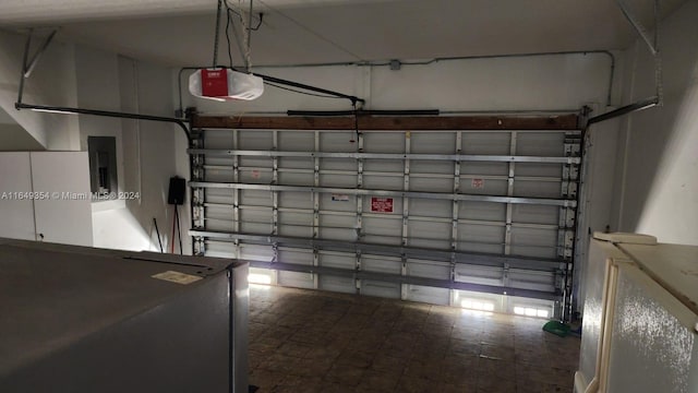 garage featuring a garage door opener and electric panel